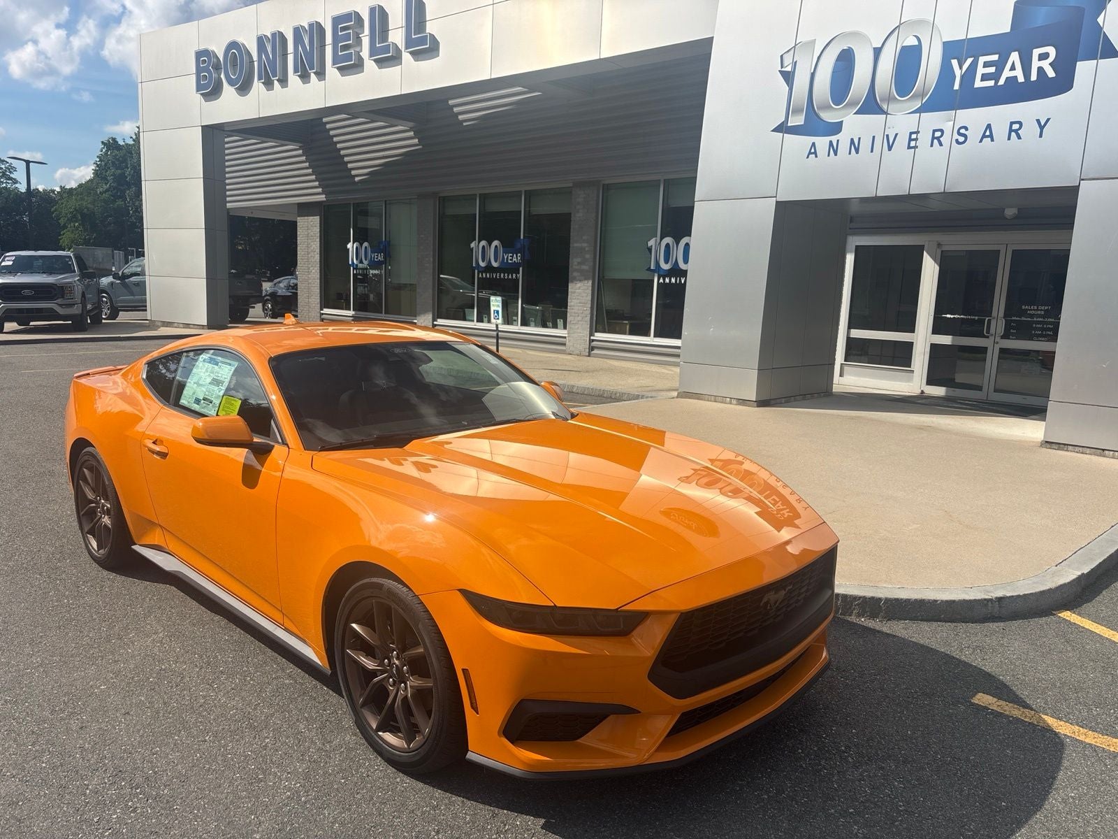 2026 Ford Mustang EcoBoost Premium in Orange Fury Metallic Tri-Coat — front three-quarter view