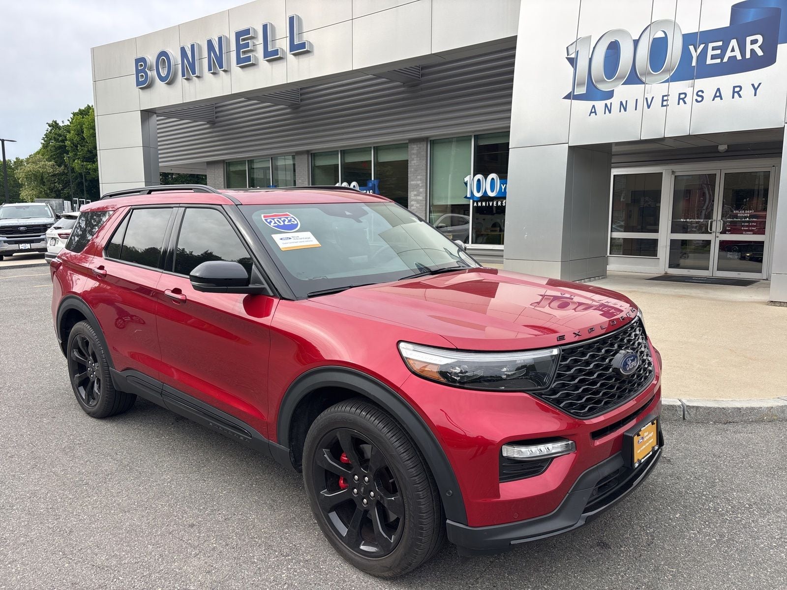 2023 Ford Explorer ST in Rapid Red Metallic Tinted Clearcoat — front three-quarter view