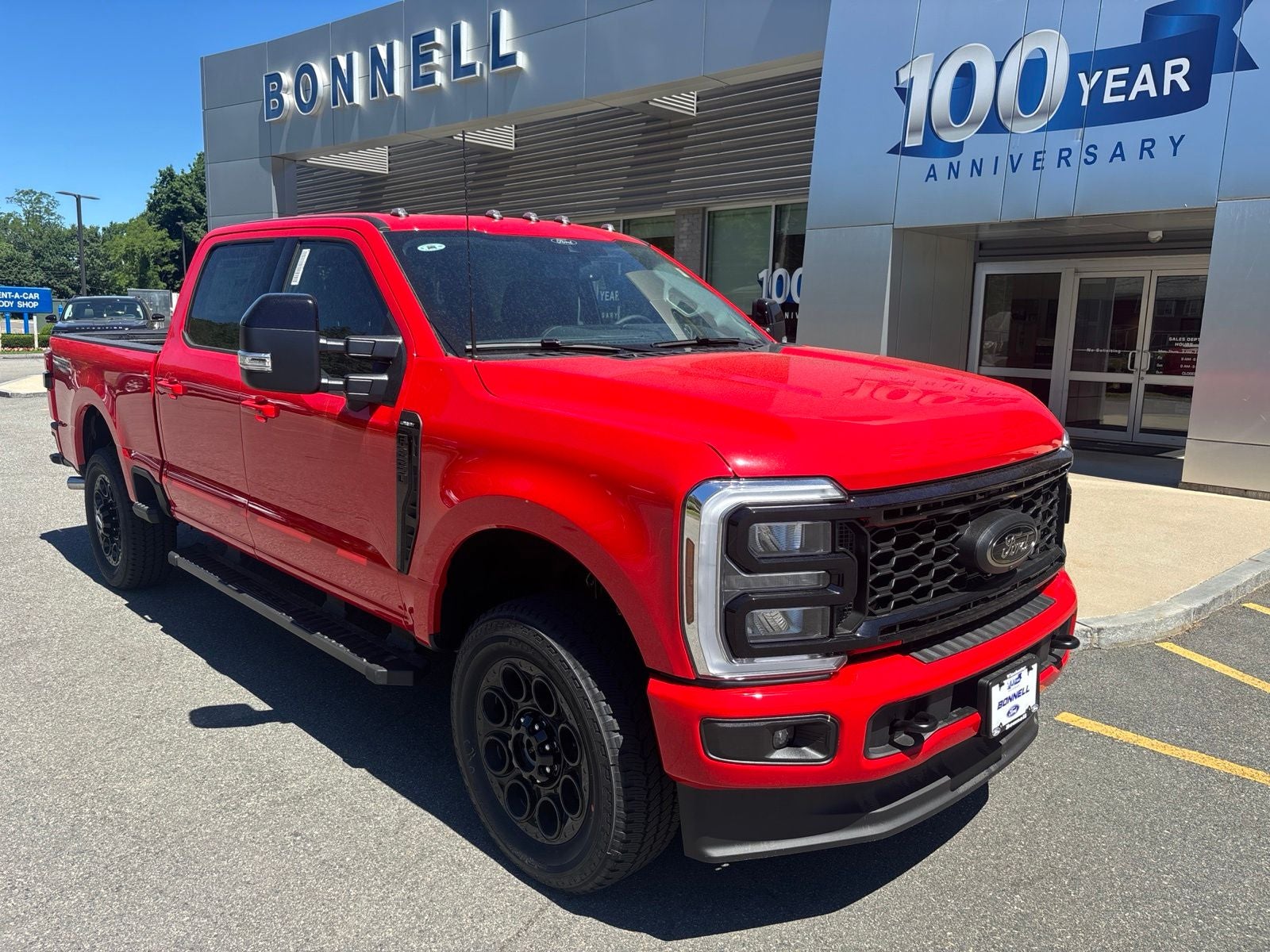 2026 Ford F-250SD Lariat in Race Red — front three-quarter view