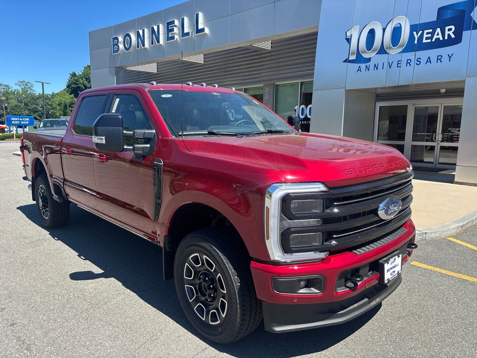 2026 Ford F-250SD Platinum in Ruby Red Metallic Tinted Clearcoat — front three-quarter view