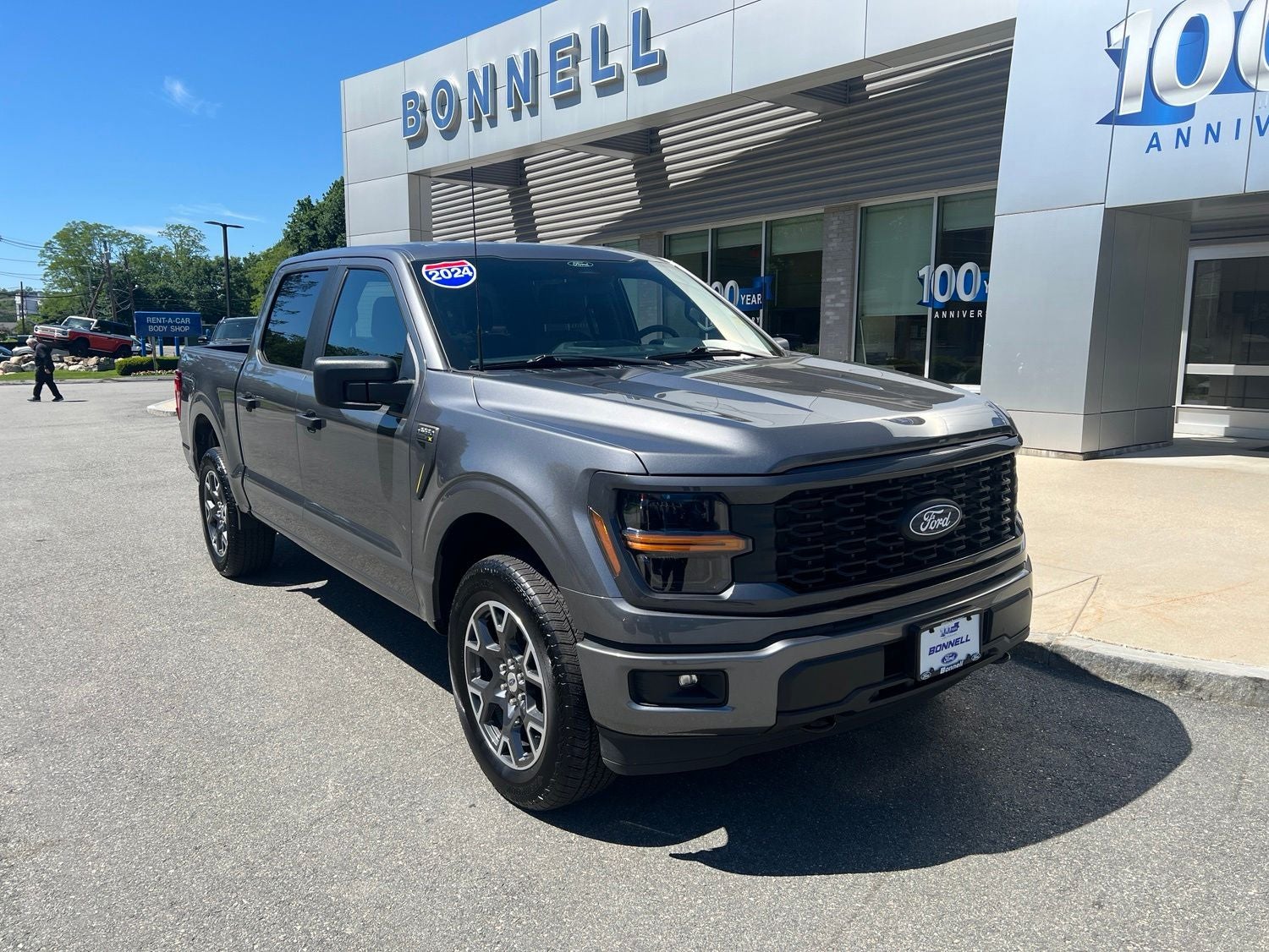 2024 Ford F-150 STX in Carbonized Gray Metallic — front three-quarter view