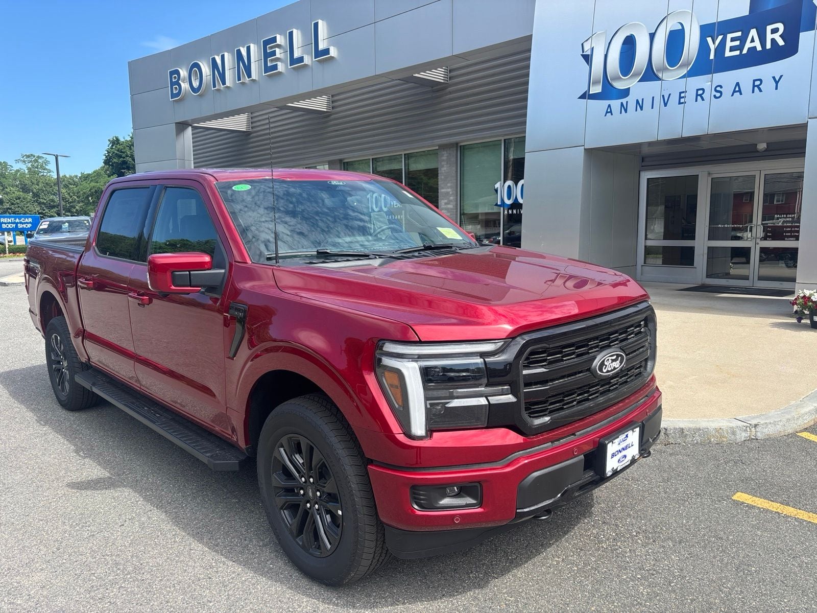 2026 Ford F-150 Lariat in Ruby Red Metallic Tinted Clearcoat — front three-quarter view