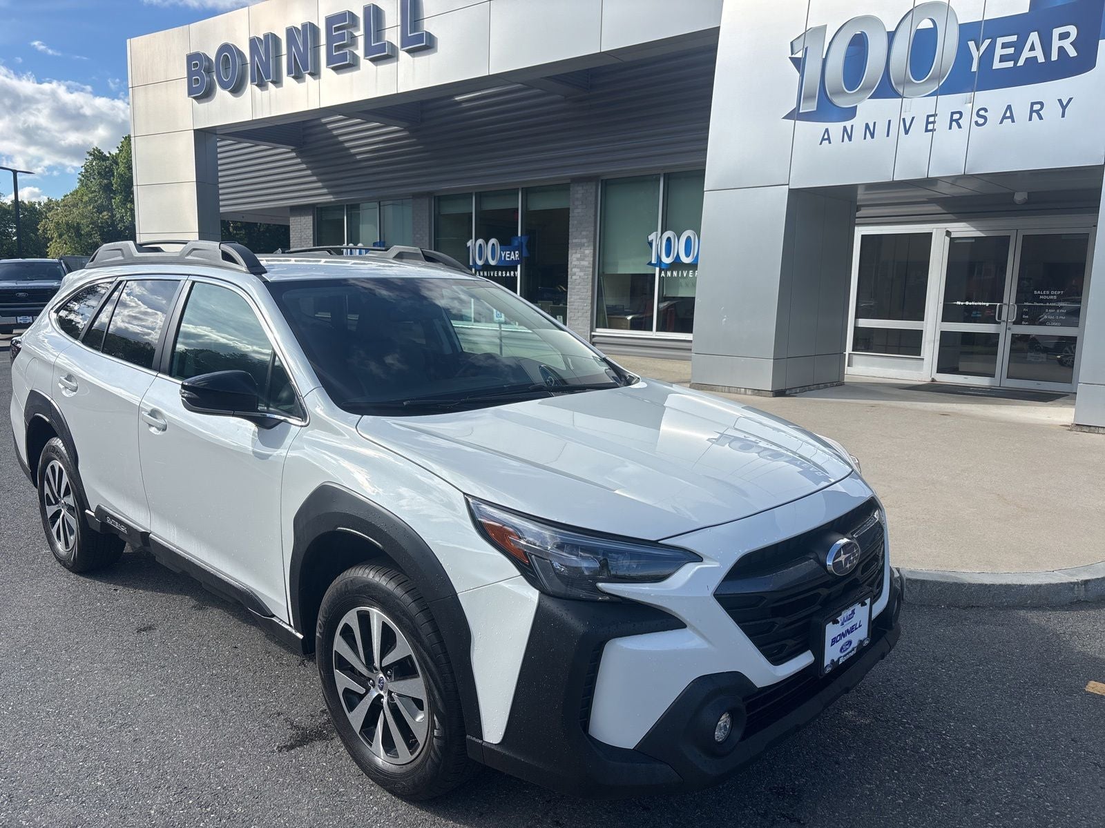2024 Subaru Outback Premium in Crystal White Pearl — front three-quarter view